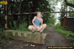 Teen blonde pisses outdoor on the road blocking stone - N