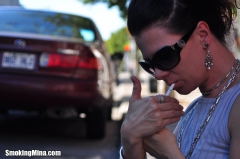 Brunette babe smoking while loitering on the street - N