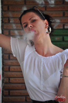 Brunette babe smoking against the wall - N