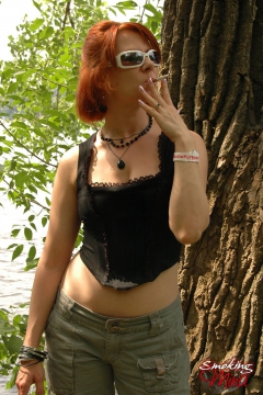 Busty babe smoking and posing sexy in the woods - N