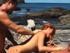 Hot Redhead In A Threesome At A Beach