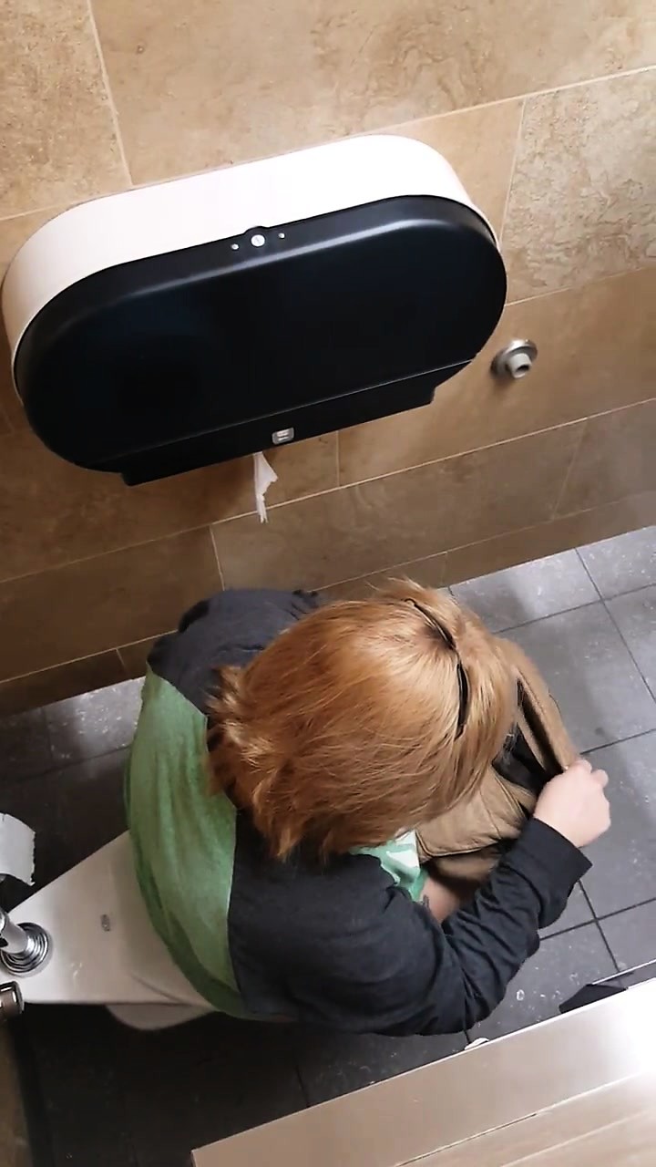 Spy Cam In The Bathroom Catches A Redhead Sitting On The To at DrTuber