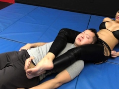 She wrestle him down on the mat and jerks off his cock