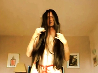 crossdressing nude with a very long black wig